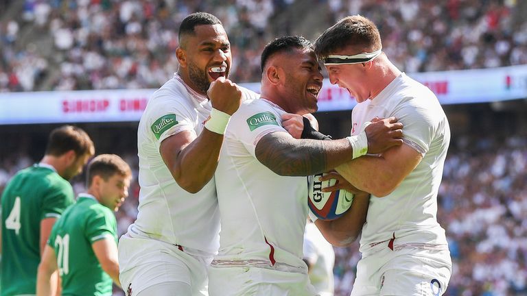 Manu Tuilagi of England celebrates with his England team-mates Joe Cokanasiga and Tom Curry 