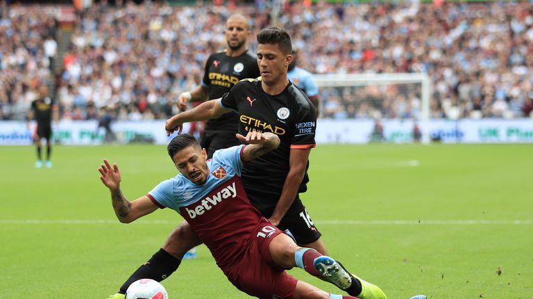 Manuel Lanzini goes down in the penalty area under pressure from Rodri