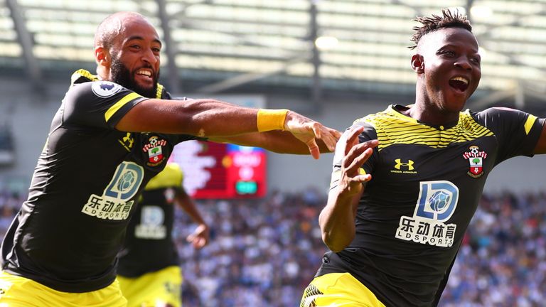 Moussa Djenepo and Nathan Redmond celebrate in Southampton's victory at the Amex Stadium