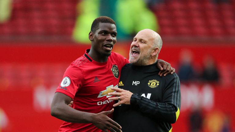 Paul Pogba celebrates the 4-0 win over Chelsea with Manchester United assistant manager Mike Phelan