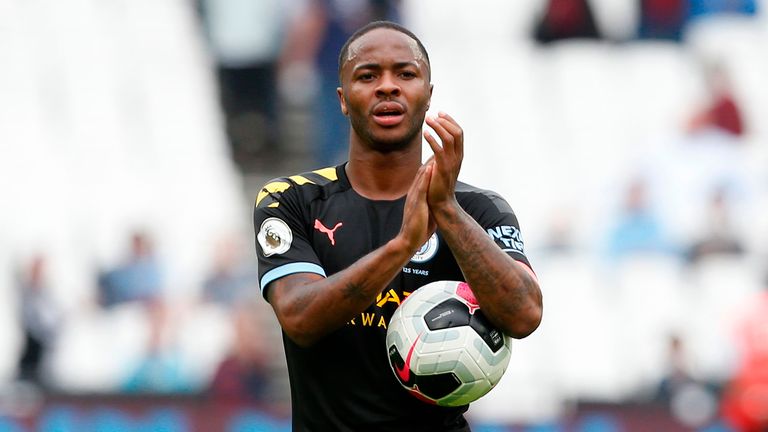 Manchester City&#39;s English midfielder Raheem Sterling applauds as he carries the match ball after scoring a hatttick to help his team win 5-0 during the English Premier League football match between West Ham United and Manchester City at The London Stadium, in east London on August 10, 2019. 