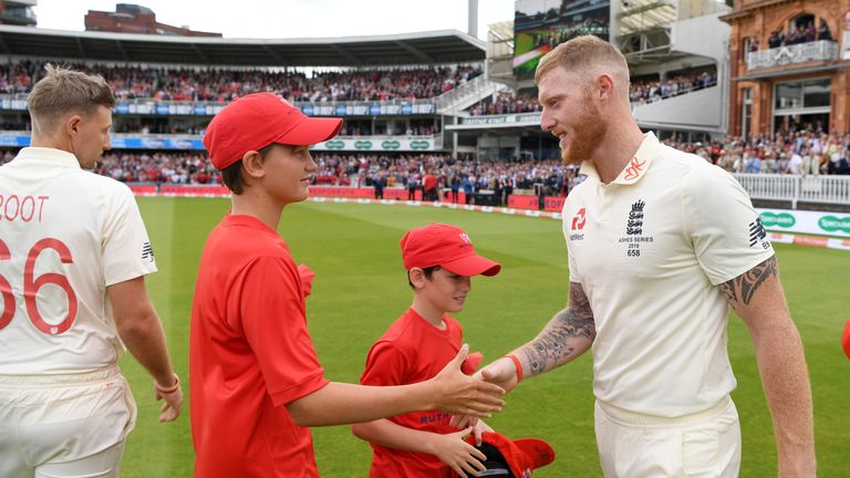 Ben Stokes hands over his commemorative cap to Luca and Sam Strauss