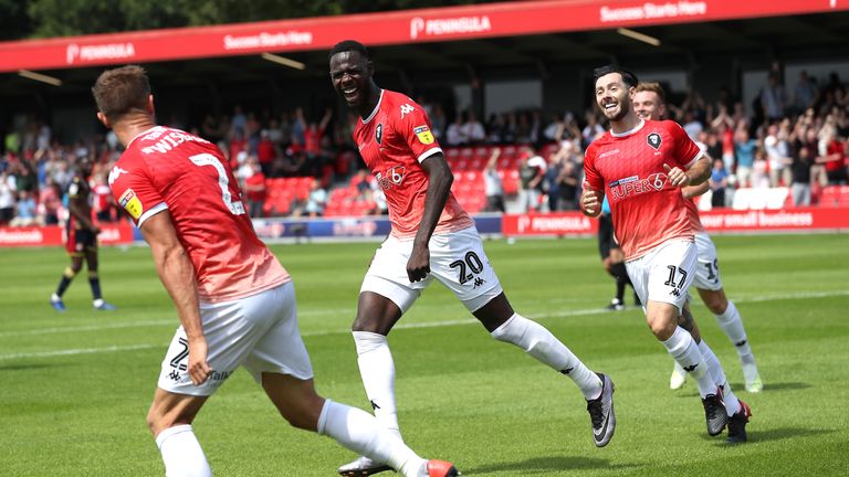 Salford City's Mani Dieseruvwe (centre) celebrates scoring his side's first goal of the game with team mates during the Sky Bet League Two match at the Peninsula Stadium, Salford. PRESS ASSOCIATION Photo. Picture date: Saturday August 3, 2019. Photo credit should read: Martin Rickett/PA Wire. RESTRICTIONS: EDITORIAL USE ONLY No use with unauthorised audio, video, data, fixture lists, club/league logos or "live" services. Online in-match use limited to 120 images, no video emulation. No use in betting, games or single club/league/player publications.