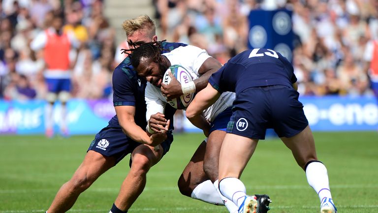 Alivereti Raka is tackled by Chris Harris and Blair Kinghorn at Murrayfield