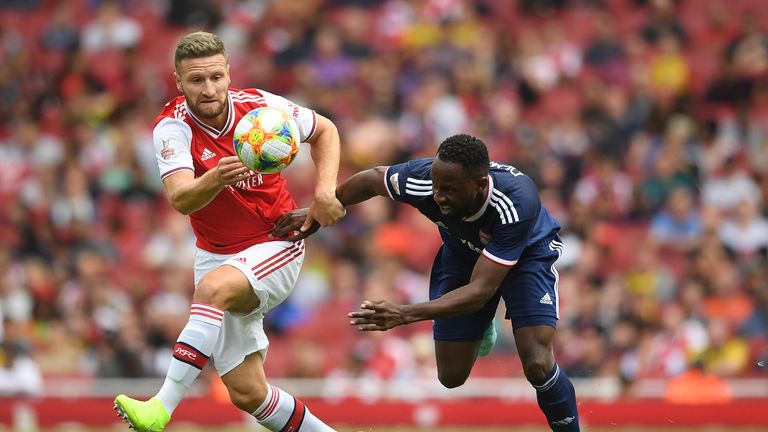 Arsenal's Shkodran Mustafi and Moussa Dembele of Olympique Lyonnais in action during the Emirates Cup