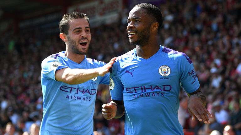 Bernardo Silva celebrates with Raheem Sterling as Manchester City score their second against Bournemouth.