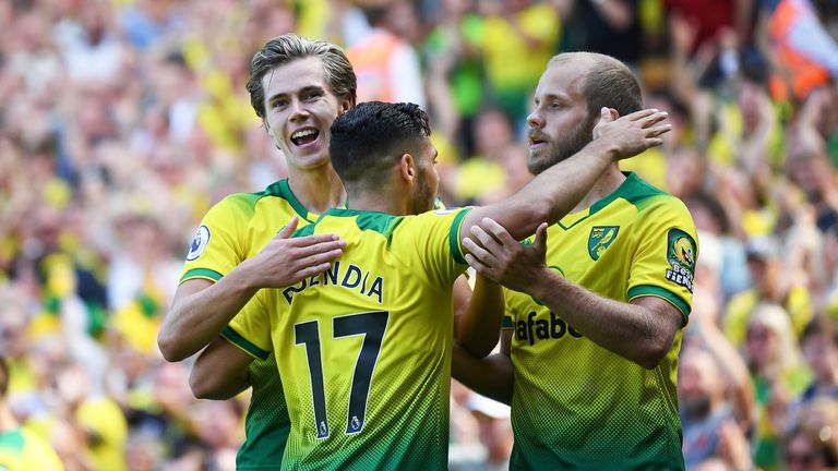 Todd Cantwell and Emiliano Buendia celebrate with goalscorer Teemu Pukki