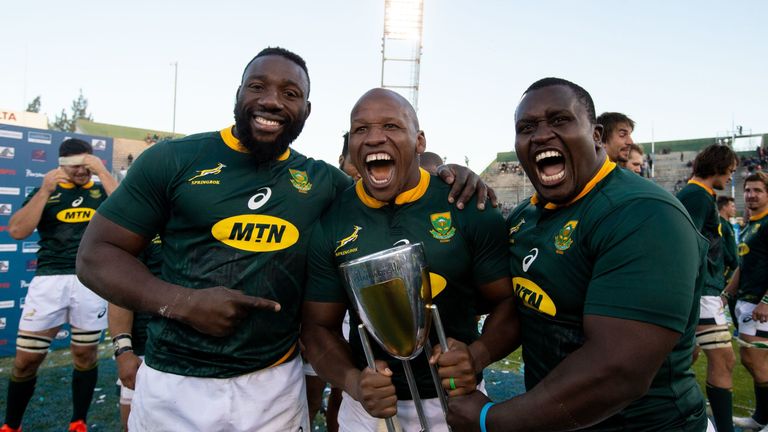 South Africa's players Tendai Mtawarira (L), Bongi Mbonambi (C) and Trevor Nyakane (R) celebrate after winning the Rugby Championship at the end of a match between Argentina and South Africa in Salta, Argentina, on August 10, 2019. - South Africa thrashed Argentina 46-13 in Salta Saturday to win the Rugby Championship for the first time. (