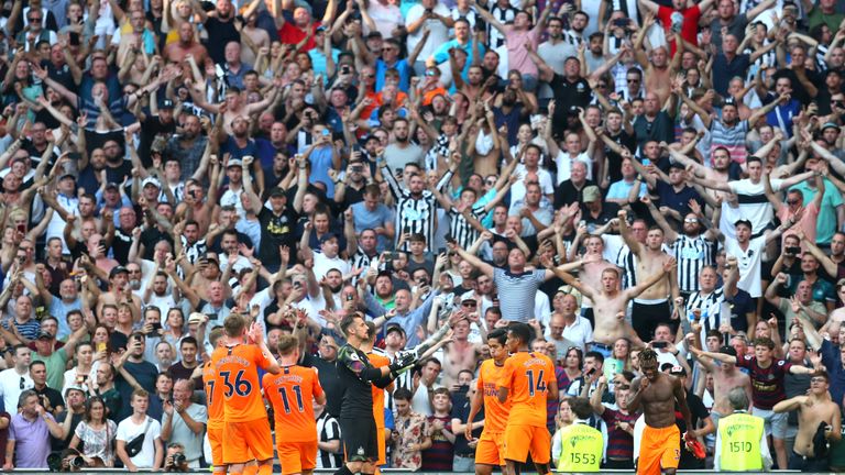 Newcastle&#39;s players and fans celebrate together at the final whistle 