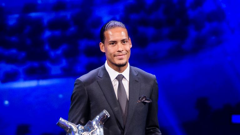 Virgil van Dijk poses with the UEFA Men&#39;s Player of the Year award