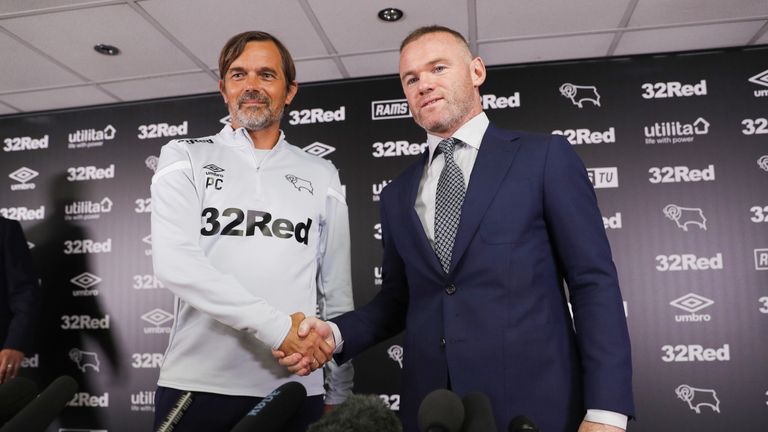 Wayne Rooney shakes hands with Derby County manager Phillip Cocu during a press conference at Pride Park