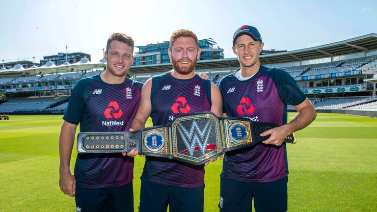England cricketers Jos Buttler, Jonny Bairstow and Joe Root with the WWE belt, customised with side plates marking England's historic ICC World Cup win
