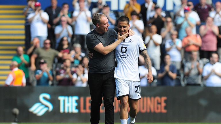 Swansea boss Steve Cooper hugs Dhanda after his performance against Birmingham