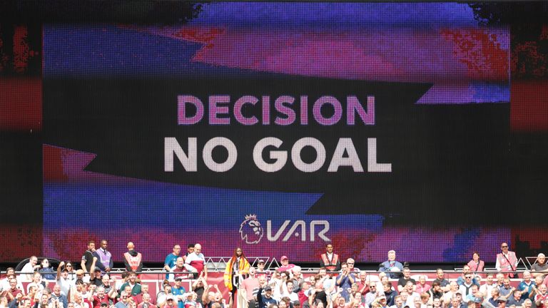 A scoreboard displays the VAR decision to disallow a goal during a match