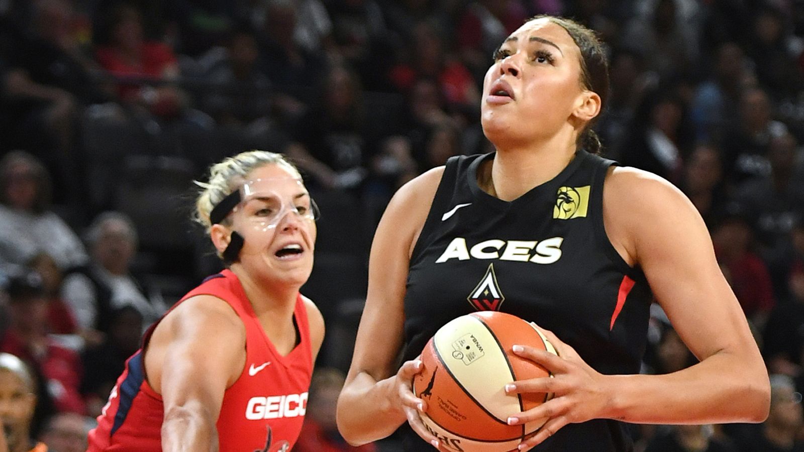 Liza Cambage drives by Elena Delle Donne to score in the Aces' Game...