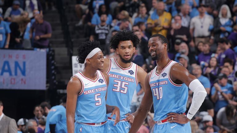 De'Aaron Fox, Marvin Bagley and Harrison Barnes share a word during a Kings game