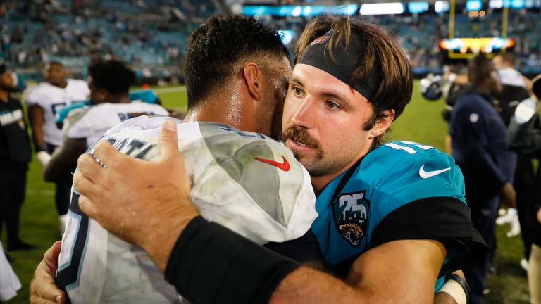 Gardner Minshew is congratulated by Titans quarterback Marcus Mariota