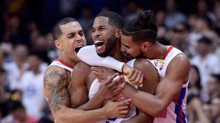 Gary Browne is mobbed by his teammates after hitting the winning basket