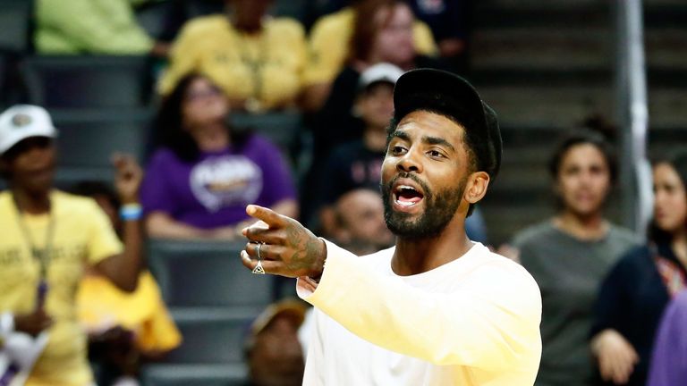 Kyrie Irving pictured on the sidelines at a WNBA game in August 2019