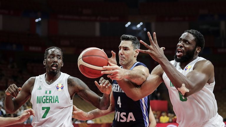 Luis Scoia competes for possession with two Nigeria defenders