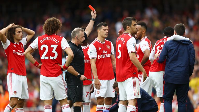 Ainsley Maitland-Niles is shown a red card for his foul on Aston Villa's Neil Taylor