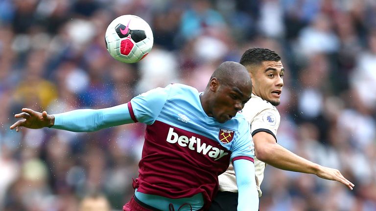 Angelo Ogbonna jumps for a header with Andreas Pereira