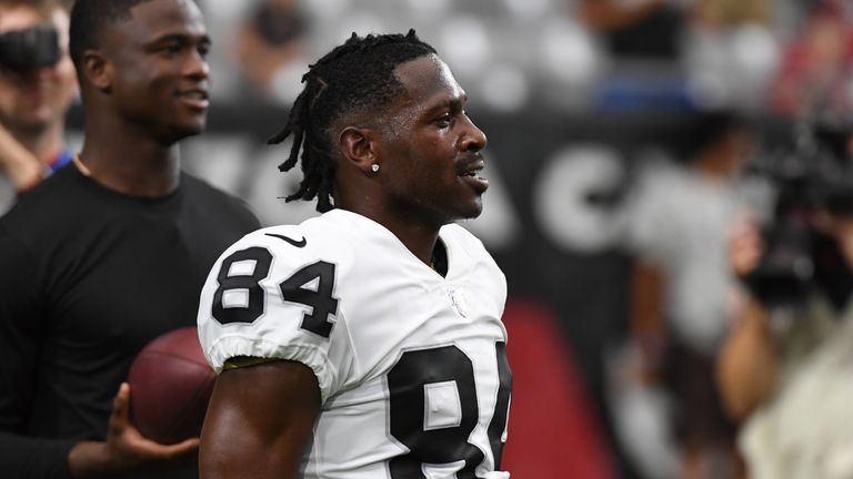 Oakland Raiders wide receiver Antonio Brown (84) plays on the sideline with  his 23-month-old so …