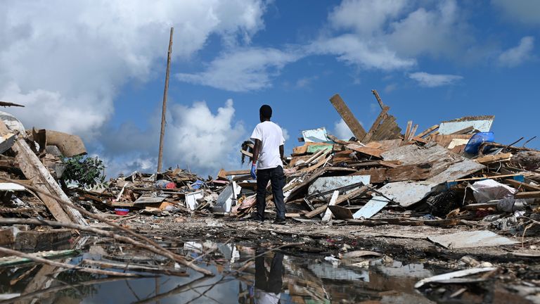 A man salvages debris in Marsh Harbour, Bahamas, on September 10, 2019, one week after Hurricane Dorian. - Bahamas authorities have updated the death toll from Hurricane Dorian to 50 with the number expected to climb, local media reported, as thousands are evacuated from the archipelago's hardest-hit islands. (Photo by ANDREW CABALLERO-REYNOLDS / AFP) (Photo credit should read ANDREW CABALLERO-REYNOLDS/AFP/Getty Images)