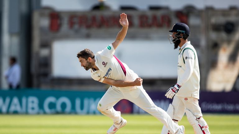 NORTHAMPTON, ENGLAND - AUGUST 20: Ben Sanderson of Northamptonshire (L) in delivery stride as Moeen Ali of Worcestershire (R) looks on during the Specsavers County Championship division two match between Northamptonshire and Worcestershire at The County Ground on August 20, 2019 in Northampton, England. (Photo by Andy Kearns/Getty Images)