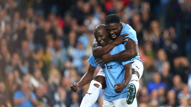 MANCHESTER, ENGLAND - SEPTEMBER 11: Benjani of Manchester City Legends celebrates with team mate Micah Richards after scoring a goal during the Vincent Kompany testimonial match between Manchester City Legends v Premier League All-Stars XI at Etihad Stadium on September 11, 2019 in Manchester, England. (Photo by Alex Livesey/Getty Imag