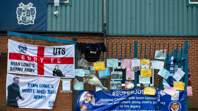Banners and messages of support are left outside Bury&#39;s Gigg Lane after the club are expelled from the EFL