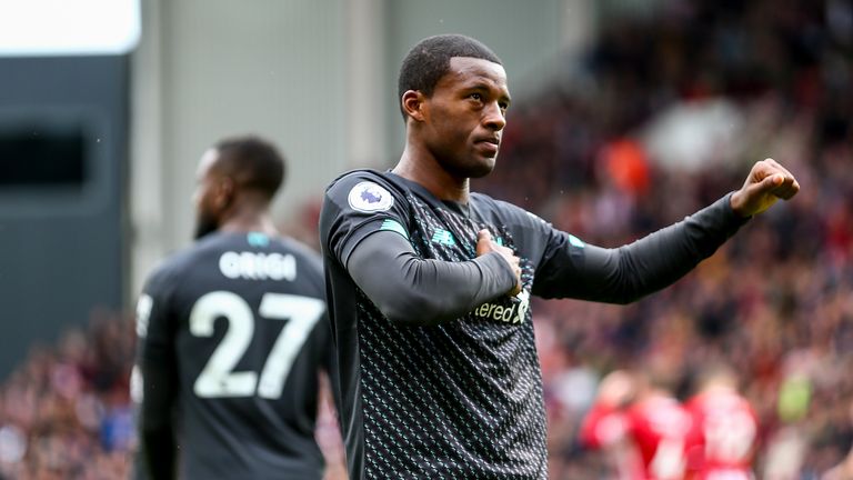 Georginio Wijnaldum places his hand on the Liverpool crest and gestures towards the crowd after giving Liverpool a 1-0 lead