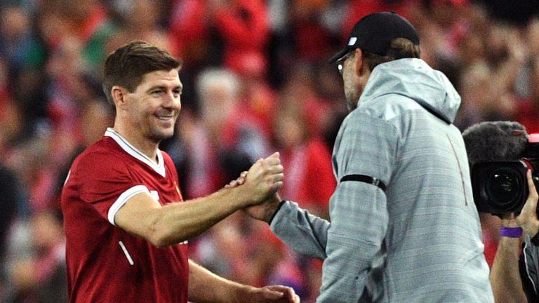 Liverpool player Steven Gerrard (2nd L) shakes hands with coach Jurgen Klopp after being substituted during their end-of-season friendly football match against Sydney FC at the Olympic Stadium in Sydney on May 24, 2017