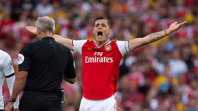 Granit Xhaka makes a point to referee Martin Atkinson during the north London derby