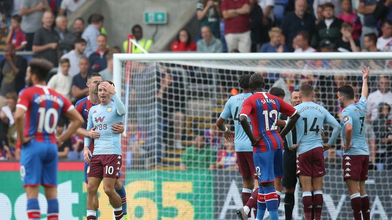 Jack Grealish is held back by Gary Cahill as Aston Villa players confront referee Kevin Friend following his decision to disallow a goal