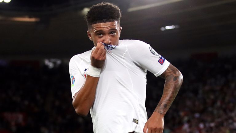 Jadon Sancho kisses the badge on his shirt after scoring England's fourth goal against Kosovo