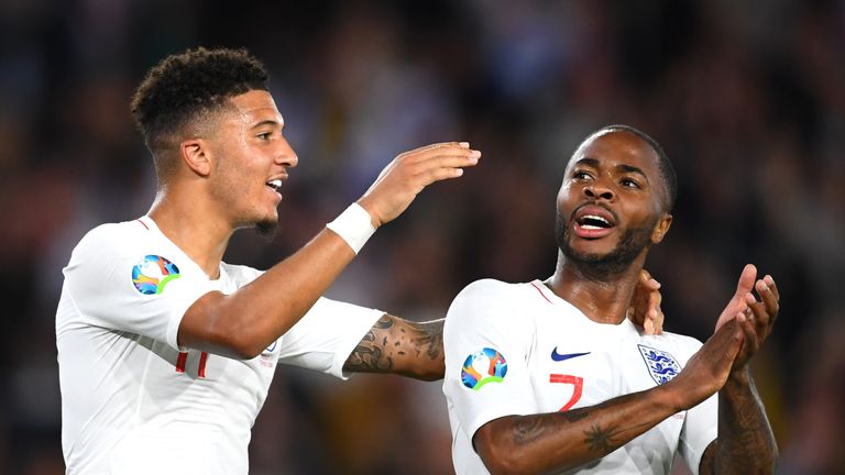 Jadon Sancho celebrates with team-mate Raheem Sterling after scoring England's fifth goal