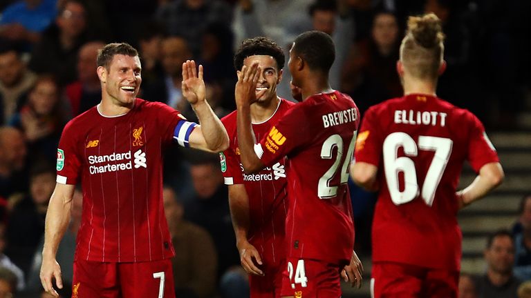 James Milner celebrates his opening strike against MK Dons on Wednesday