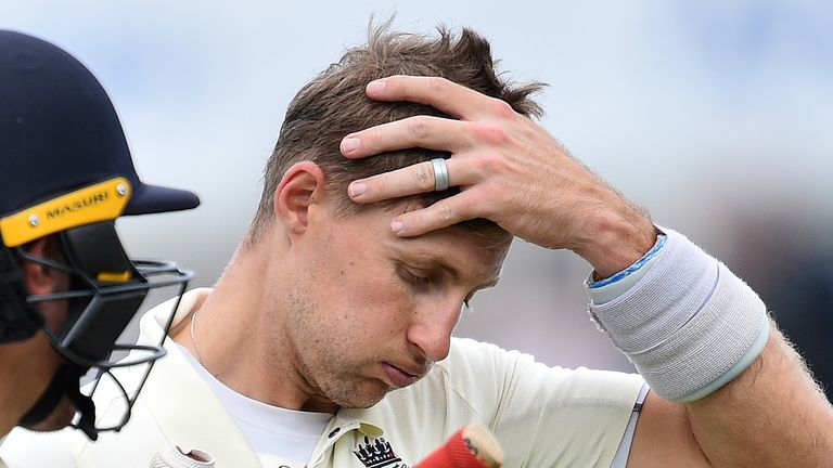 England&#39;s captain Joe Root (R) reacts as he and England&#39;s Rory Burns walk back to the pavilion during a break for lunch on the first day of the fifth Ashes cricket Test match between England and Australia at The Oval in London on September 12, 2019. 