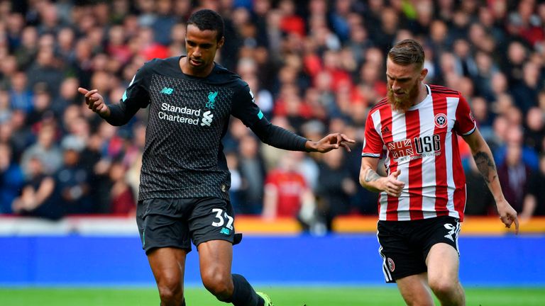 Joel Matip tries to hold off Oliver McBurnie