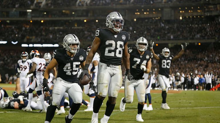 Josh Jacobs of the Oakland Raiders celebrates after scoring his second touchdown of the game against the Denver Broncos