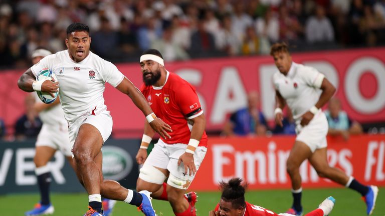 Manu Tuilagi runs past Leva Fifita during the Rugby World Cup 2019, Pool C game between England and Tonga