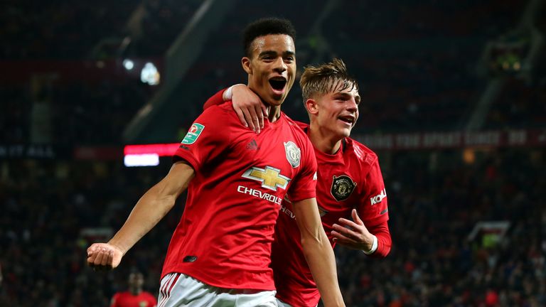 Mason Greenwood of Manchester United celebrates scoring his teams first goal of the game with team mate Brandon Williams during the Carabao Cup Third Round match between Manchester United and Rochdale AFC at Old Trafford
