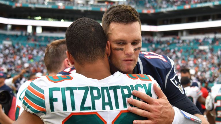 Tom Brady embraces then Miami Dolphins safety Minkah Fitzpatrick