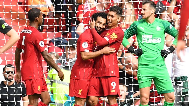 Mohamed Salah celebrates with Roberto Firmino after making it 3-1 to Liverpool