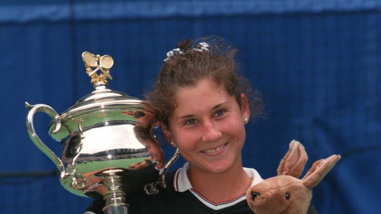 Monica Seles of the USA celebrates with the Australian Open trophy after defeating Anke Huber of Germany to win the final of the Ford Australian Open 1996 at Flinders Park in Melbourne, Australia