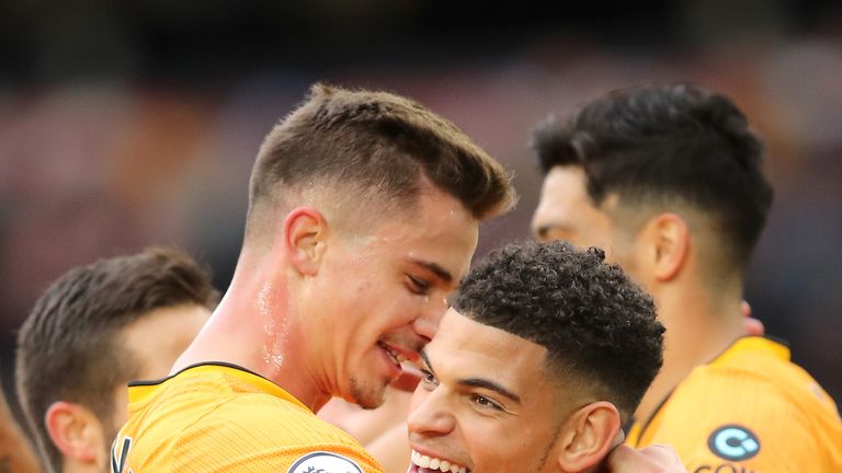 Morgan Gibbs-White and Leander Dendoncker celebrate after Watford&#39;s Daryl Janmaat puts the ball into his own net