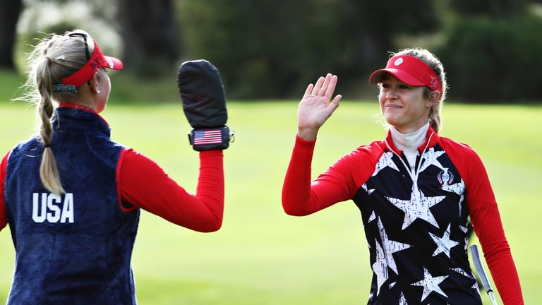 Nelly Korda (R) and Jessica Korda (L) of Team USA high five on the fifth green