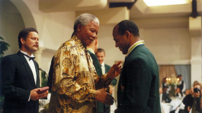 JANUARY 01: Former President Nelson Mandela shakes the hand of Springbok player, Chester Williams.