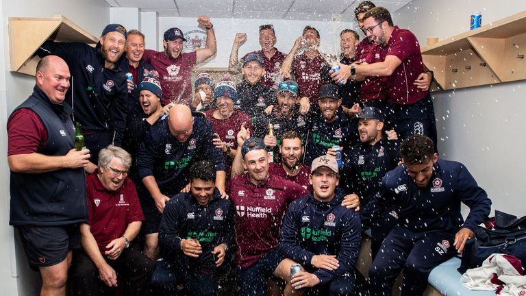 The Northamptonshire squad celebrate promotion to Division One after play on day four was cancelled to a rain sodden outfield during the Specsavers County Championship Division Two match between Gloucestershire and Northamptonshire at Bristol County Ground on September 26, 2019 in Bristol, England.